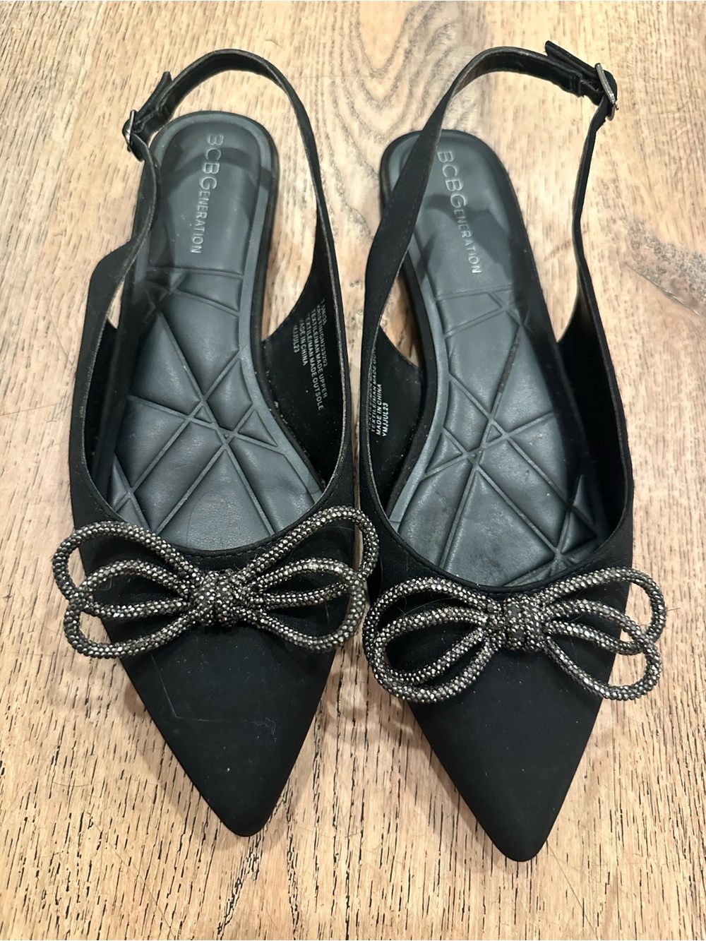 BCBGeneration Black Pointed Slingback Flats with Metallic Bow Accent